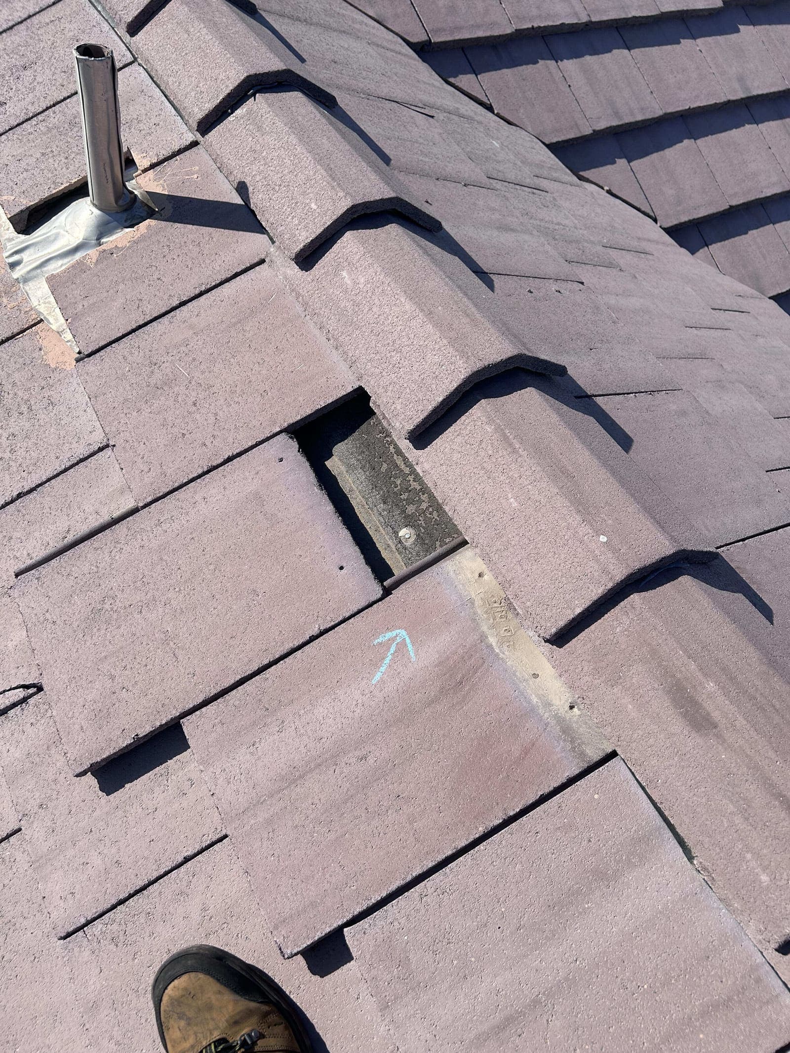 Broken roof tile marked for repair
