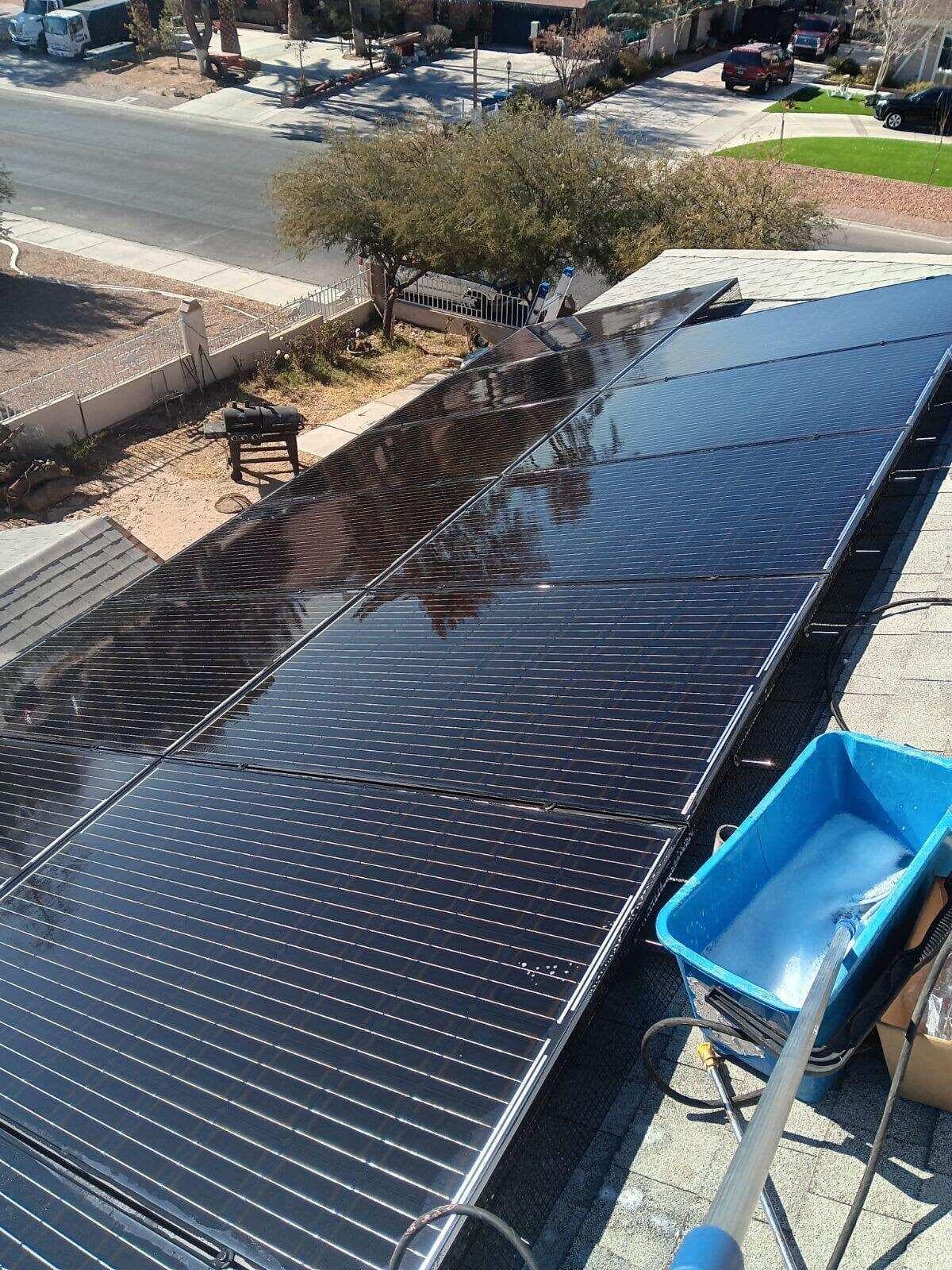 Solar panel cleaning tools on a residential roof